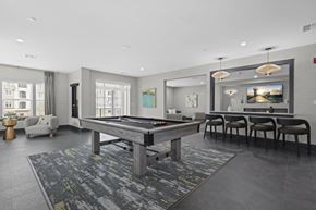 Florham Park apartment for rent - A billiard table is in the middle of a room with a grey carpet.