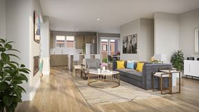 Springfield apartment for rent - A modern townhome living room with a grey sofa and a wooden floor.