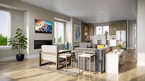 Springfield apartment for rent - A modern townhome living room with a large couch, a coffee table, and a TV mounted on the wall.