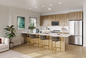 Florham Park apartment for rent - A modern kitchen with a bar area and a refrigerator.