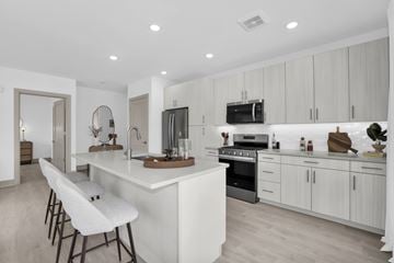 Englewood Cliffs apartment for rent - A modern kitchen with white cabinets and a large island.