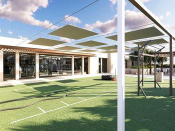 Outdoor fitness area with turf and shade canopies