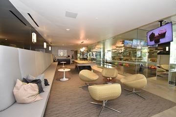 San Diego apartment for rent - A modern living room with a white couch and a television.