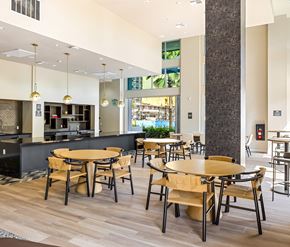 Irvine apartment for rent - Community kitchen with dining tables and pendant lighting at Elements Apartments, Irvine