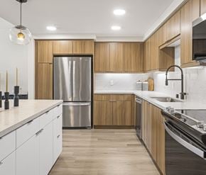 San Diego apartment for rent - Bright apartment kitchen with wooden cabinets and stainless-steel appliances.