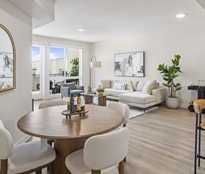 San Diego apartment for rent - A modern dining room with a wooden table and white chairs.