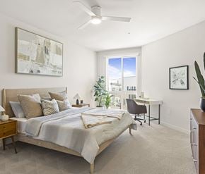 San Diego apartment for rent - A spacious apartment bedroom with natural light and a ceiling fan.