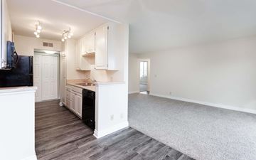 Sherman Oaks apartment for rent - A kitchen with white cabinets and a black fridge.