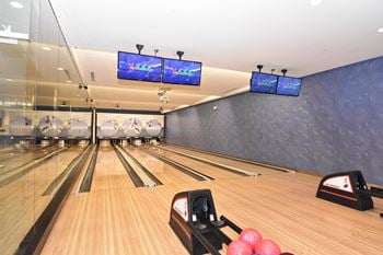 Bowling alley with multiple lanes and overhead scoring