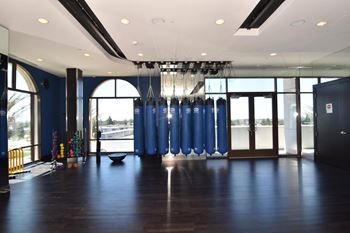 Fitness studio with punching bags and arched windows