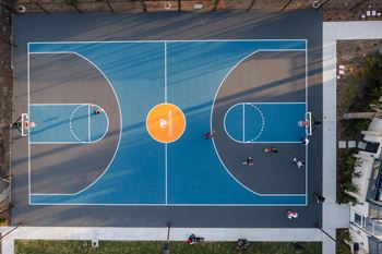 Aerial of outdoor basketball court with players