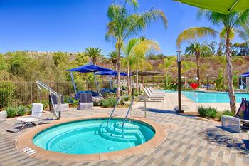 Circular spa with metal handrail and paver deck