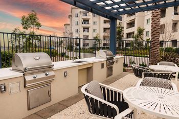 Outdoor grilling area with built in bbqs and dining tables