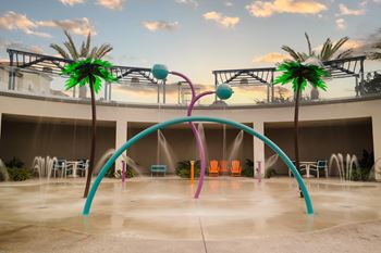 Splash pad with colorful arches and water features