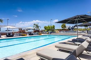 Irvine apartment for rent - Rooftop swimming pool with lounge chairs and umbrellas at Elements Apartments, California, 92612