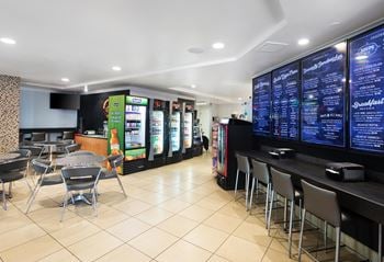 A restaurant with a counter and chairs
