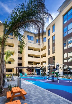 Irvine apartment for rent - Outdoor courtyard playground with colorful equipment and palm trees at Metropolis Apartments, IRVINE, CA 92614