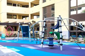 Irvine apartment for rent - Childrens play area with climbing structure and blue surfacing at Metropolis Apartments, IRVINE, CA