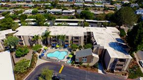 San Diego apartment for rent - A large building with a pool in front of it.at Pacific Bay Club Apartments, San Diego, CA