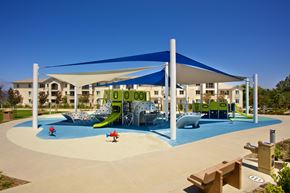 San Diego apartment for rent - Shaded playground with colorful equipment and slides at Torrey Gardens Apartments, San Diego, CA 92130