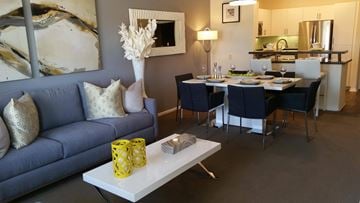 San Diego apartment for rent - A living room with a blue couch and a white coffee table.