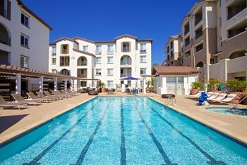 Resort style swimming pool with lane markings and lounge chairs