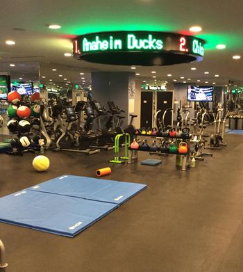 Fitness center with cardio equipment and scoreboard display