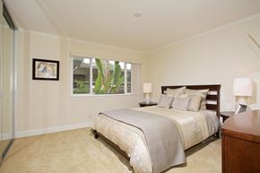 La Jolla apartment for rent - A bedroom with a large bed and a picture on the wall.