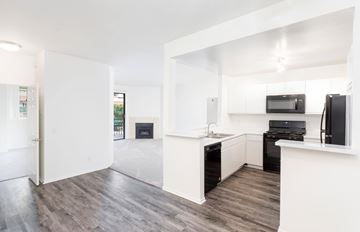 Encino apartment for rent - A modern kitchen with a black stove top oven and microwave.