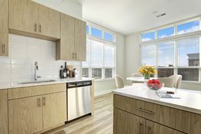 Hackensack apartment for rent - A kitchen with wooden cabinets and a white countertop.