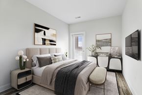 Hackensack apartment for rent - A bedroom with a large bed and a painting on the wall.