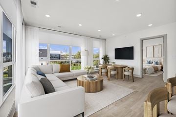 Englewood Cliffs apartment for rent - A modern living room with a white sofa and a wooden coffee table.
