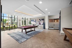 Englewood Cliffs apartment for rent - A room with a pool table and a view of the outside.