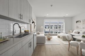 Englewood Cliffs apartment for rent - A modern studio kitchen with white cabinets and a large window.