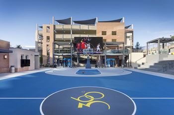 Outdoor basketball court with large video screen