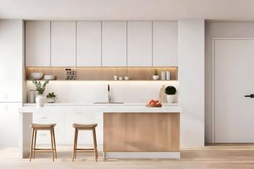 Newton apartment for rent - A modern kitchen with a white countertop and wooden bar stools.