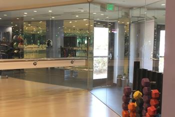 Fitness studio with ballet barre and mirrored walls