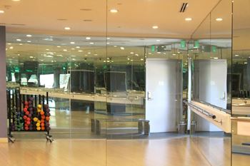 Fitness studio with mirrored walls and barre rail