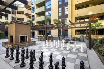Outdoor chess board with oversized pieces and courtyard seating
