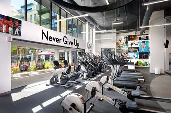 Fitness center with cardio equipment and motivational wall art