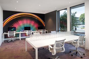 Modern workspace with colorful rainbow wall mural