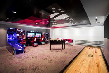 Game room with arcade machines and shuffleboard table