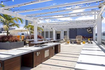 Rooftop outdoor kitchen with grill stations and pergola