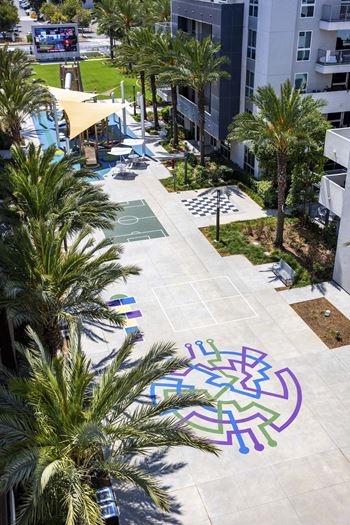 Aerial view of courtyard with basketball court and colorful ground art