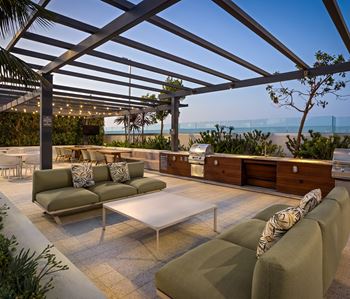 Rooftop lounge with built in outdoor kitchen and ocean views