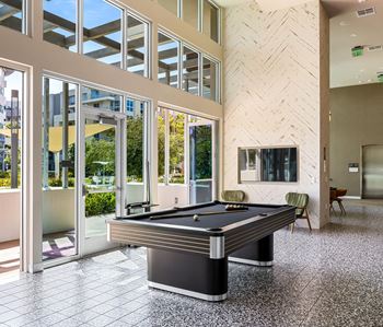 Recreation room with pool table and herringbone accent wall