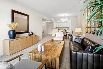 San Diego apartment for rent - A living room with a black leather couch and a wooden coffee table.