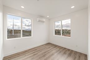 Hurricane apartment for rent - A spacious room with a view of the outdoors through large windows.