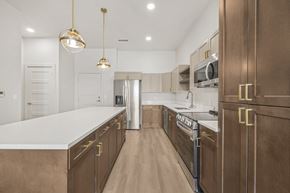 Idaho Falls apartment for rent - A kitchen with brown cabinets and a white countertop.