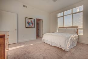 West Point apartment for rent - A bedroom with a large bed and a painting on the wall.